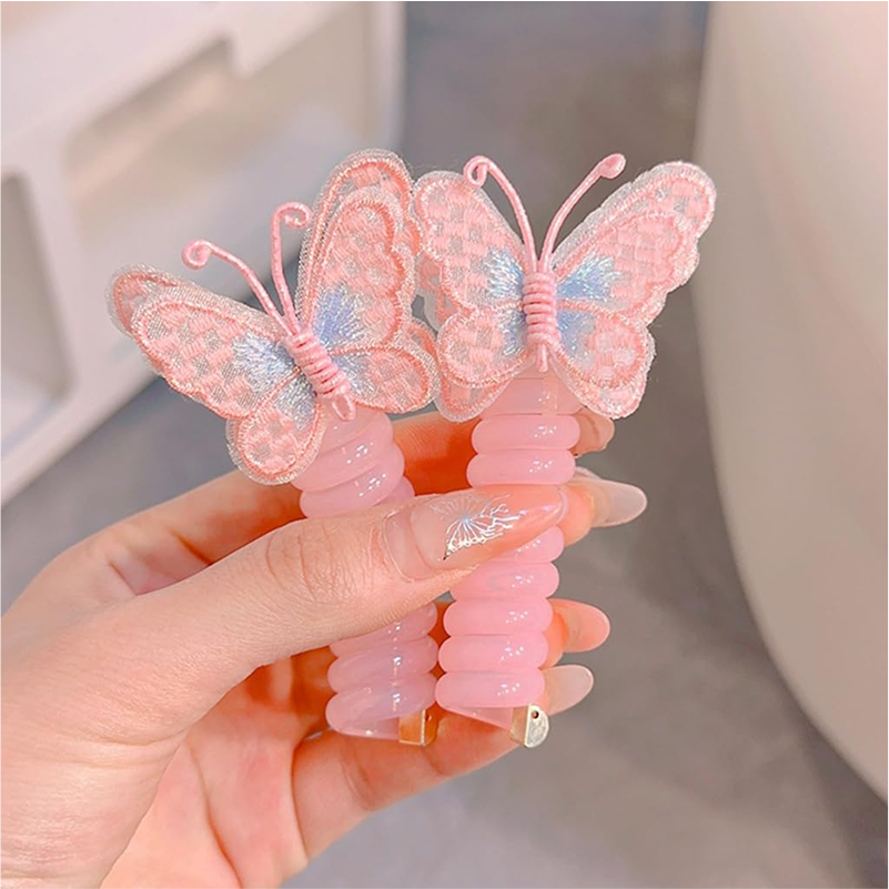 Two pink and yellow butterfly charm hair ties on a white background