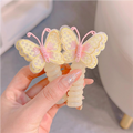 Two pink and yellow butterfly charm hair ties on a white background